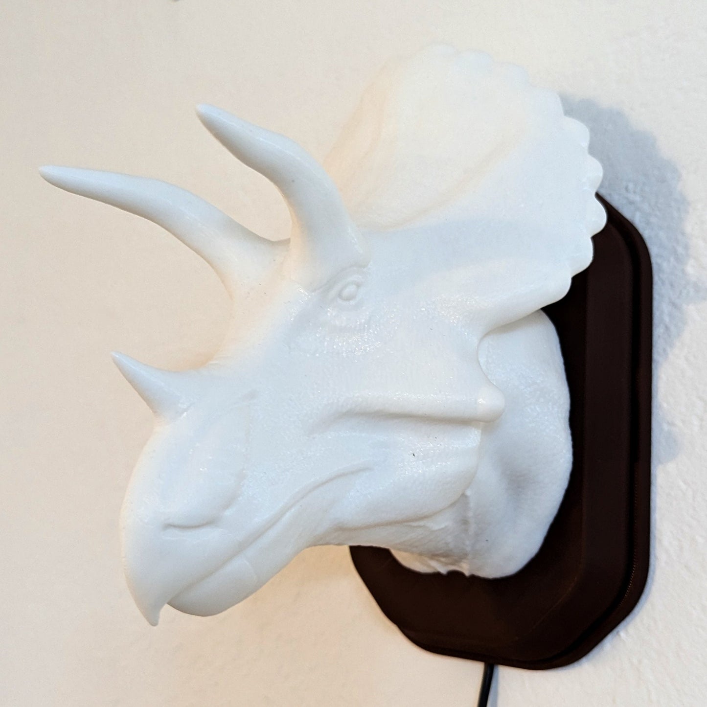 Triceratops inspired wall trophy lamp to decorate your room: bedroom, playroom or office.