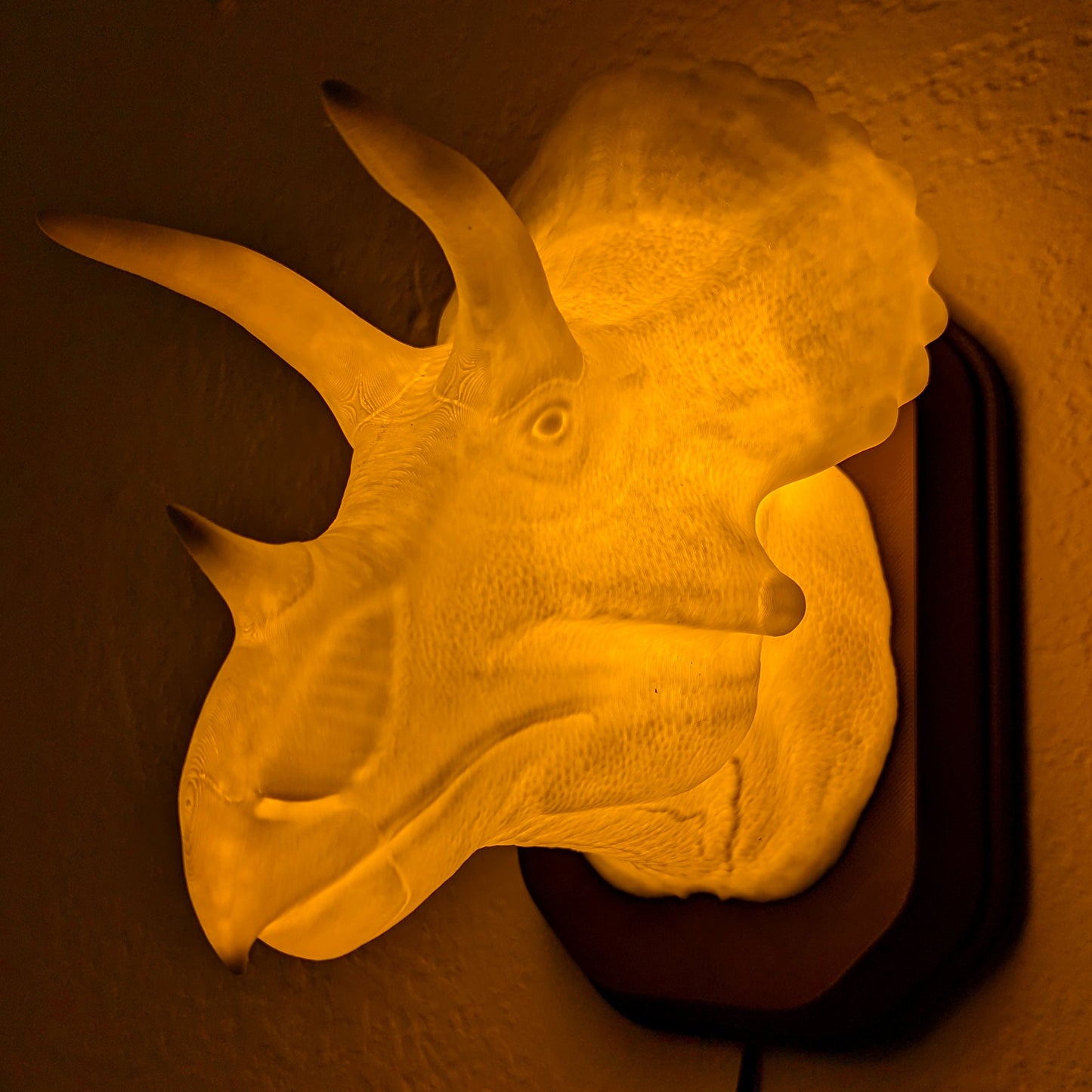 Triceratops inspired wall trophy lamp to decorate your room: bedroom, playroom or office.