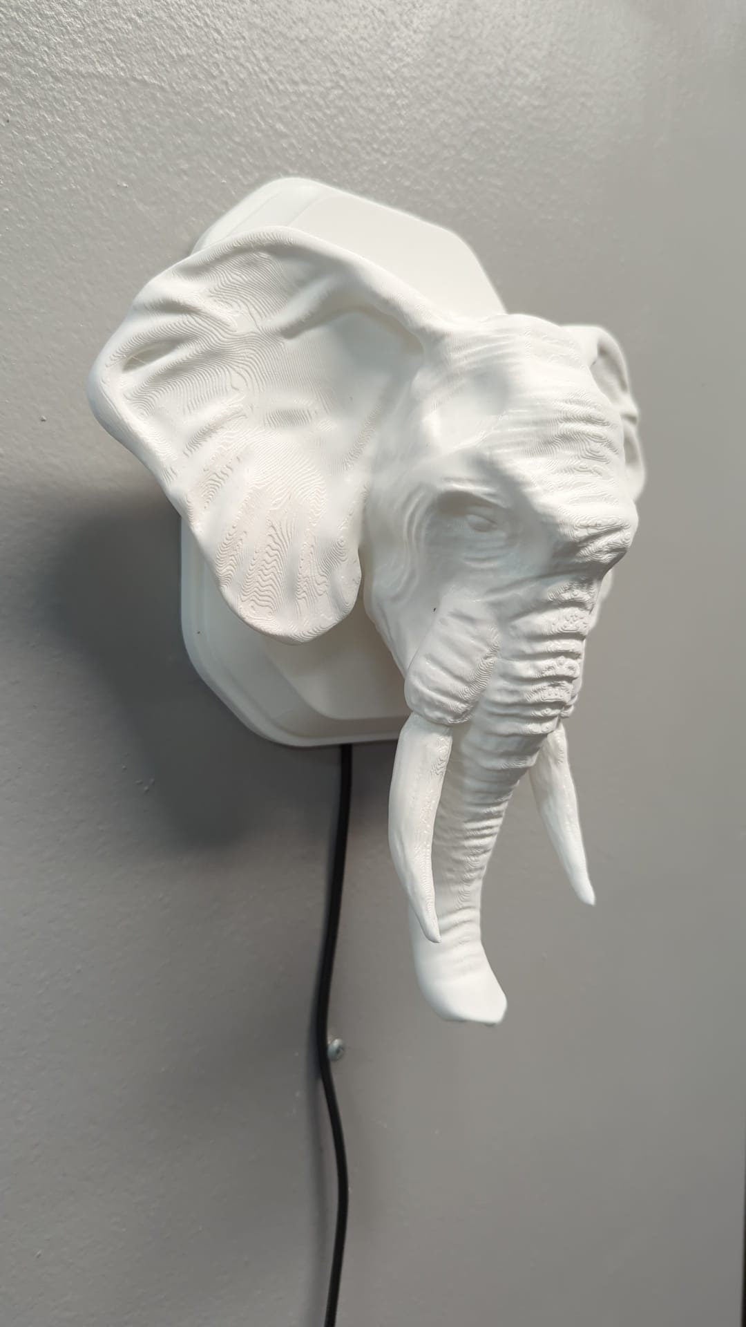 Elephant-inspired wall trophy lamp to decorate your room: bedroom, game room or office.