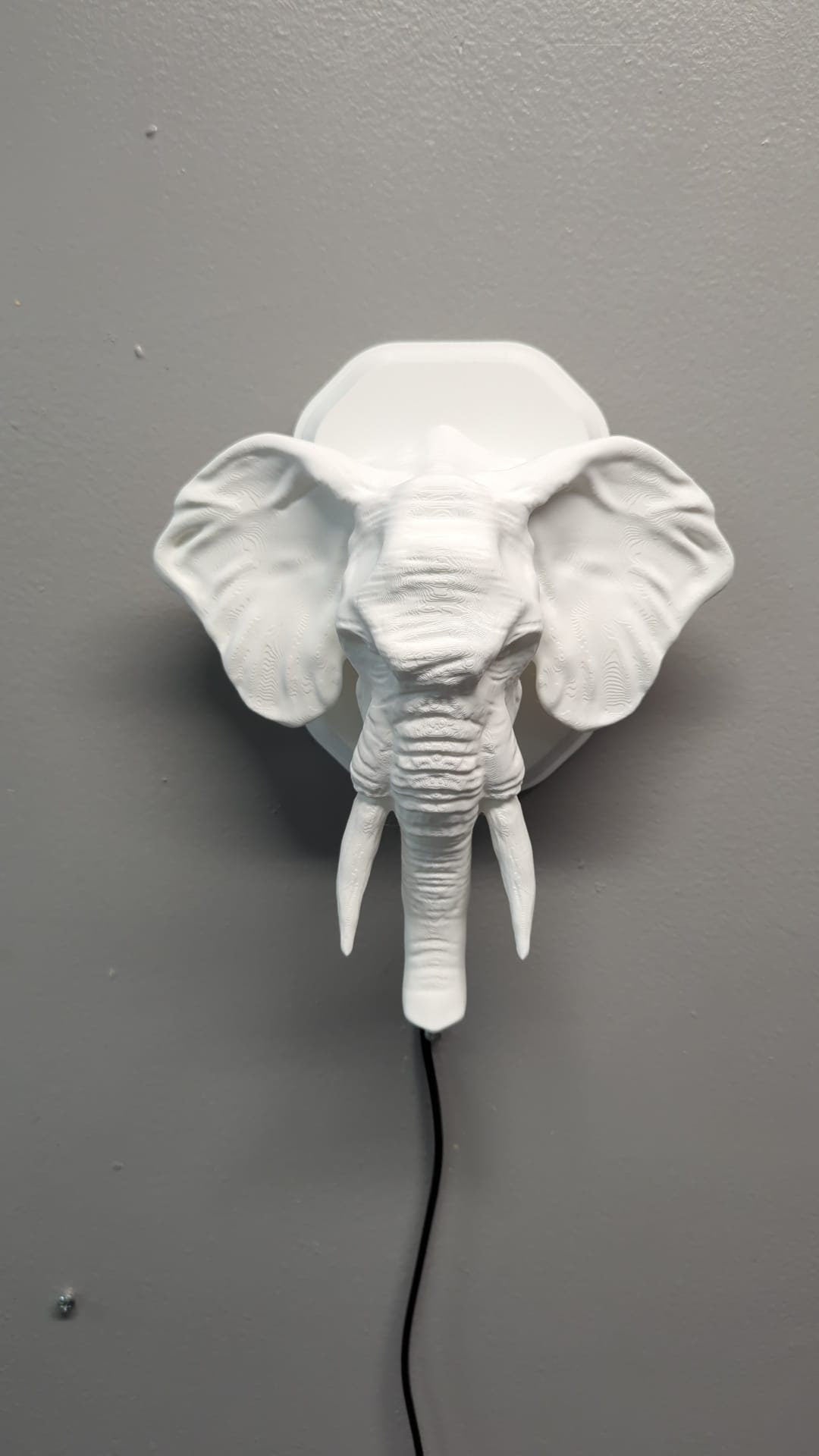 Elephant-inspired wall trophy lamp to decorate your room: bedroom, game room or office.