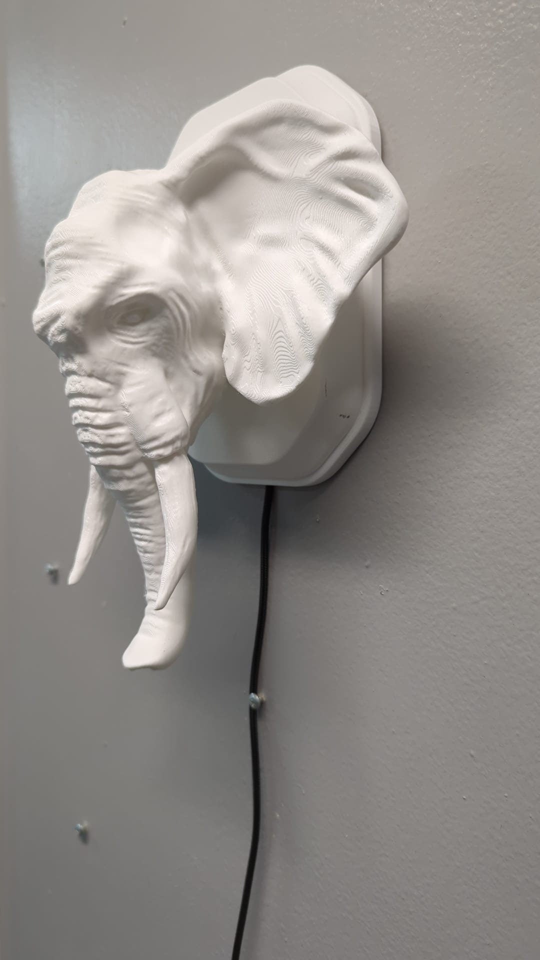Elephant-inspired wall trophy lamp to decorate your room: bedroom, game room or office.