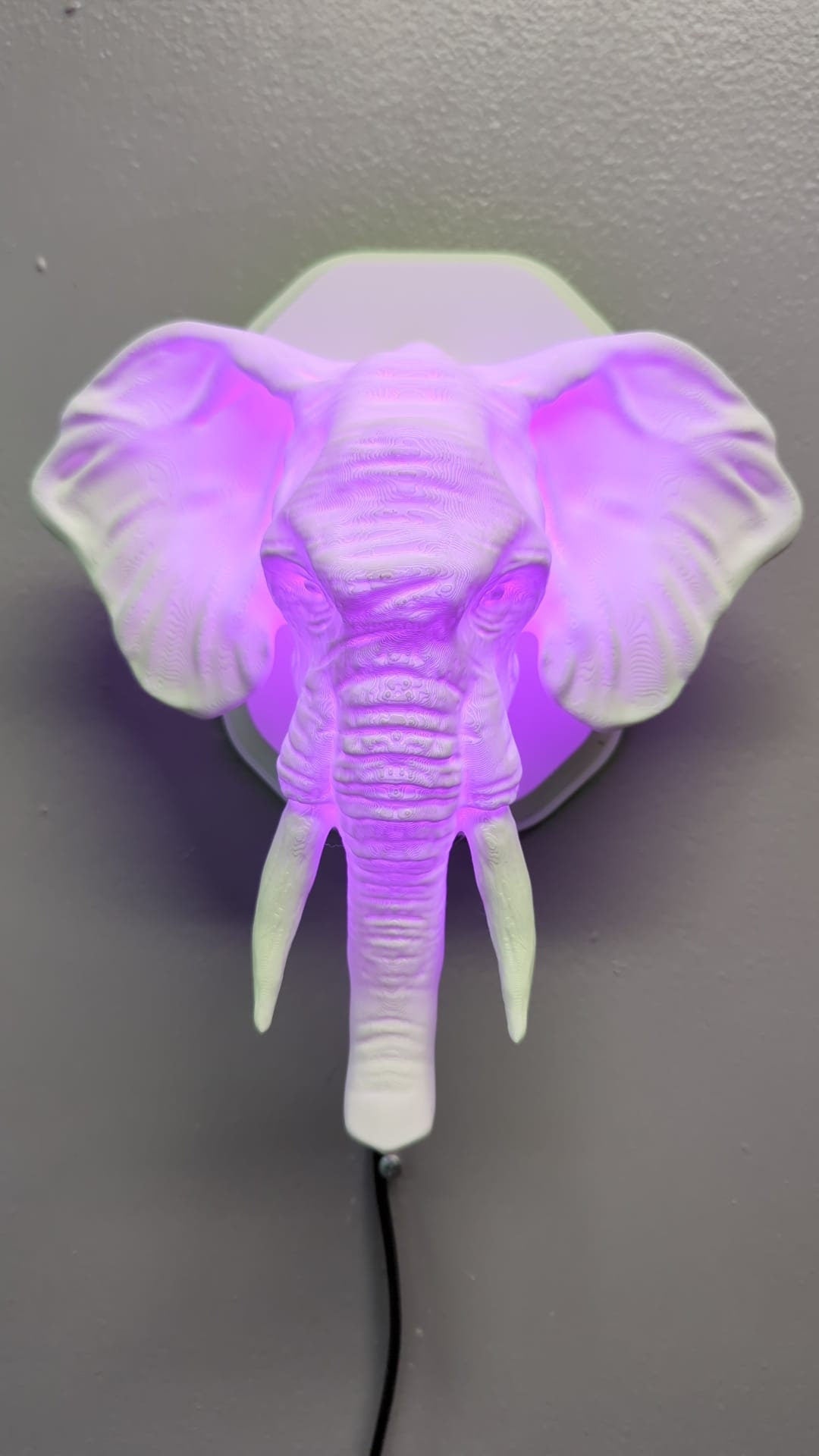 Elephant-inspired wall trophy lamp to decorate your room: bedroom, game room or office.