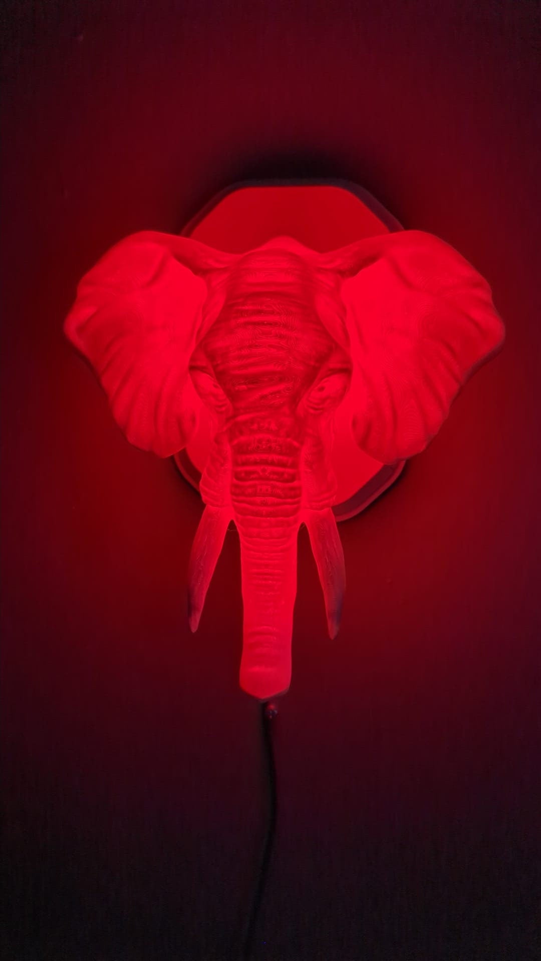 Elephant-inspired wall trophy lamp to decorate your room: bedroom, game room or office.