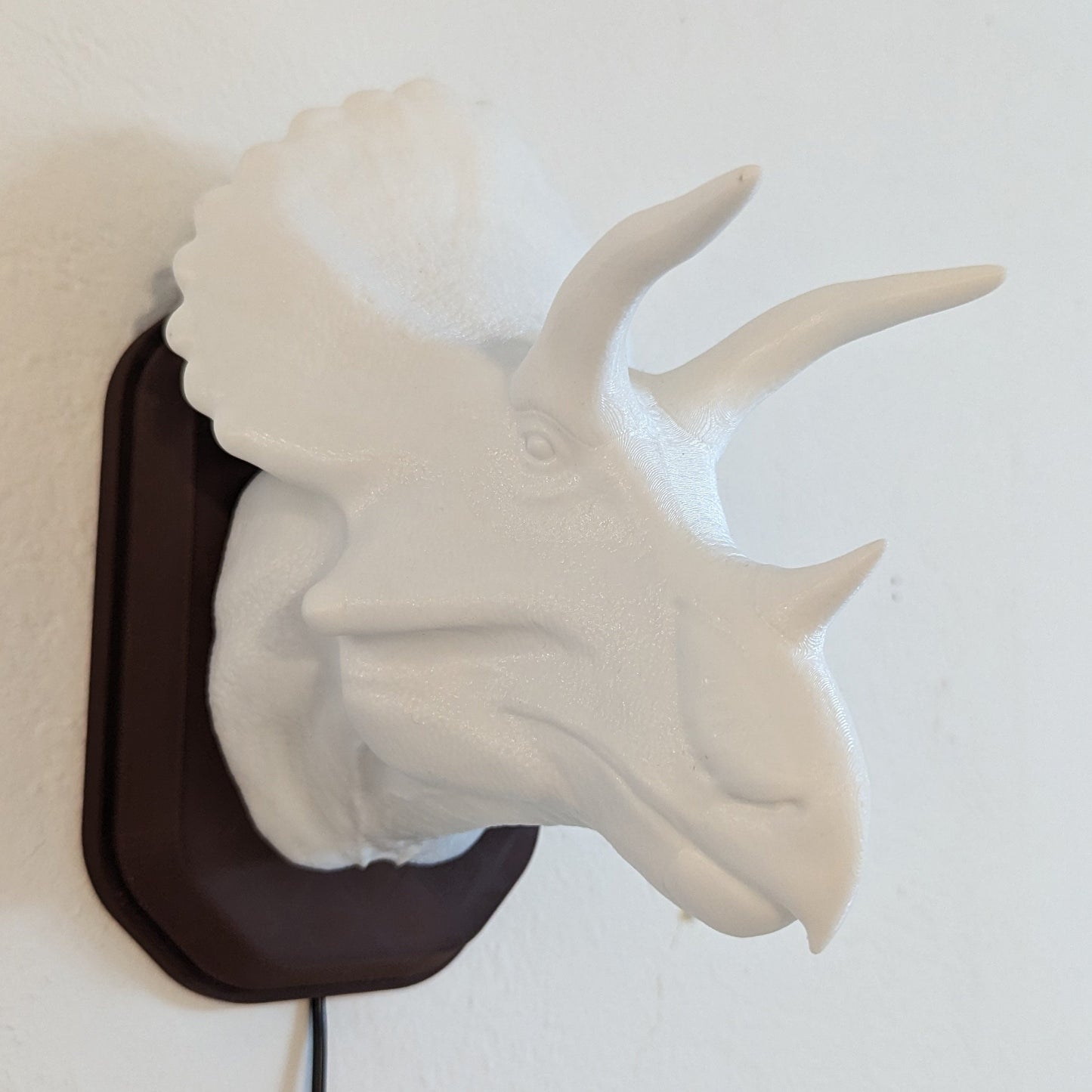 Triceratops inspired wall trophy lamp to decorate your room: bedroom, playroom or office.